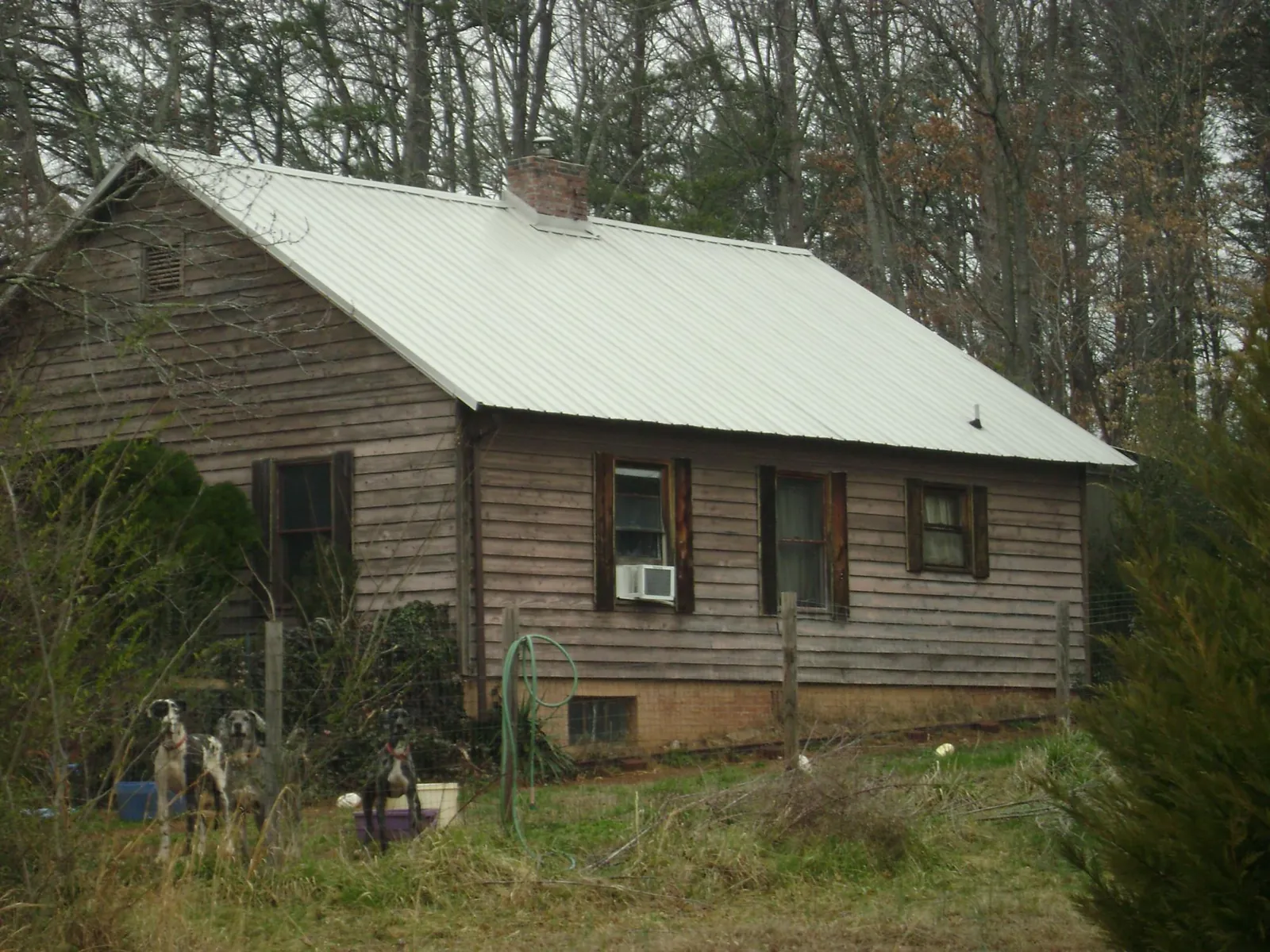 White metal roof on an old wood sided farmhouse, from a Metal Roof Installation job in Mount Olive